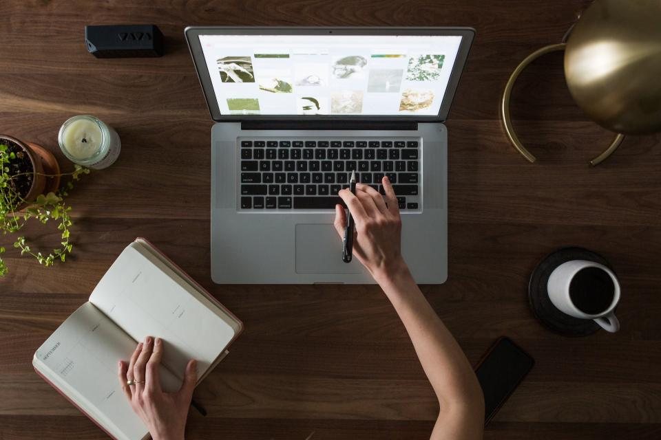 Laptop and notebook on a desk